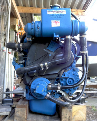 Engine front, showing Jabsco raw water pump mounted on the front crank shaft pulley. Aslo alternator pulley, relative size.