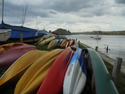 colourful canoes against a pretty monochrome background Alnmouth
