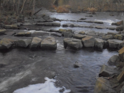 The fish Pass round the weir fashioned from boulders