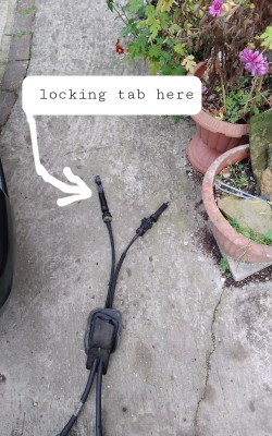 Locking tab location to gear cable balljoint