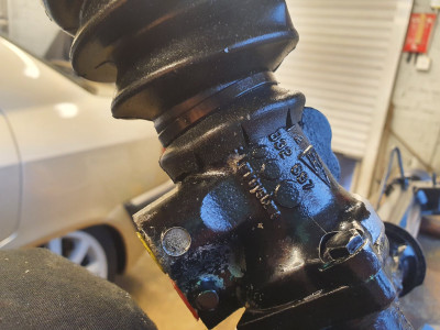 Held by a cable tie and I didn't touch the unused boss that sticks out the side because it helps keep the gaiter on even if it slightly skews it.