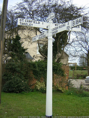 Direction Sign – Signpost on the B184 in High Roding village<br />Located on the east side of the crossroads of the B184 Dunmow Road, Canfield Road and Rands Road, High Roding. In High Roothing parish. 4 arms and half-moon finial.<br /><br />Milestone Society National ID: EX_TL6017