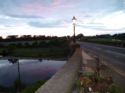 The river gently made its way under the bridge