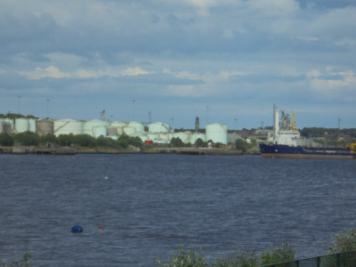 Because of the curvature of the river<br />South Shields Town Hall Clock tower appears between the storage tanks to be on the North Side of the River.