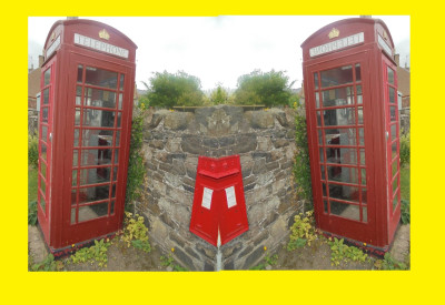 An oddity a red telephone box with a telephone in it.