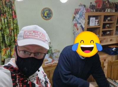 A man, a hat, and another man