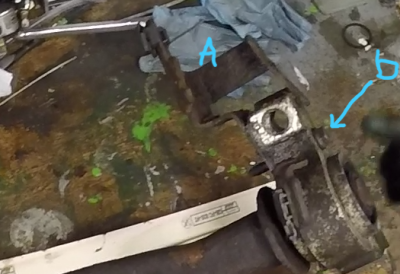 A is the height sensor bracket, b. is the seized screw. Had to snap it in the end - it was corroded not where it screws into the metal bracket but inside the alloy casting where it travels through a clearance hole. This hole was full of the corrosion product again.