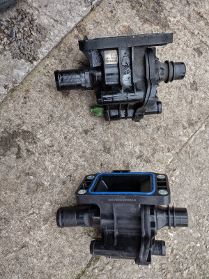New and old coolant manifold thermostat housing