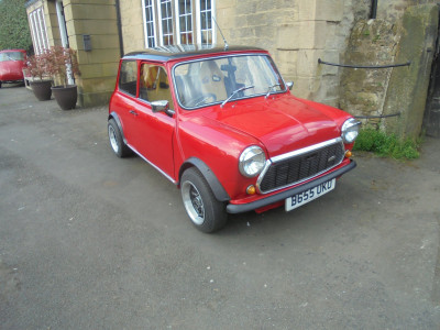 A Red mini with a black roof