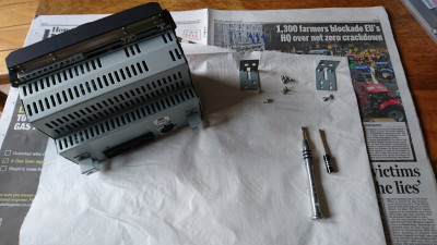 I started by removing the mounting brackets to make it easier to lay on any side.