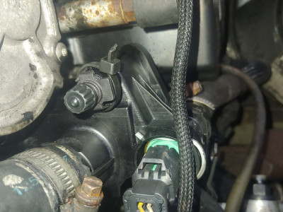 Thermostat with bleed valve, viewed from front of van