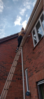 Cleaning the guttering.