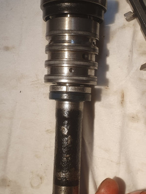 Pinion valve shaft with ring and oil seal in their positions.