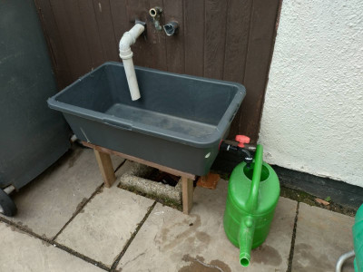 The can in place with outlet to fill it.
