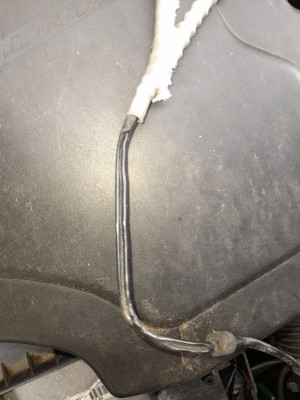 White sheathing peeled back revealing 6inch section of melted vacuum pipe